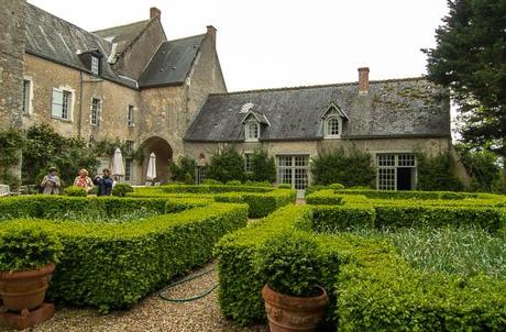 Back of house with hedged plantings