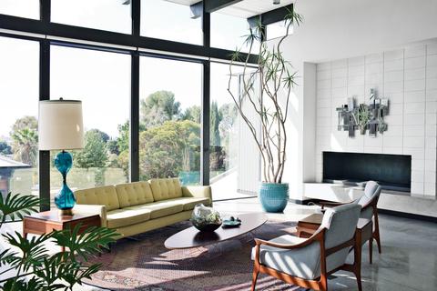 Yellow sofa, gray chairs, low coffee table, floor-to-ceiling windows