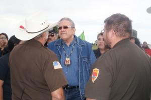 Police approach President Brewer as the march begins.