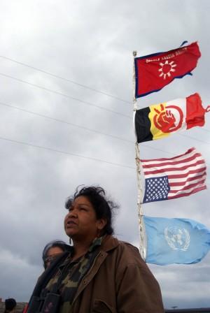 Olowan Martinez watches the crowd gather before the blockade of beer trucks at White Clay.