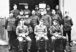 That's Low, at center front, surrounded by a crew of other sour faced chaps of the Experimental Works staff of the Royal Flying Corps.