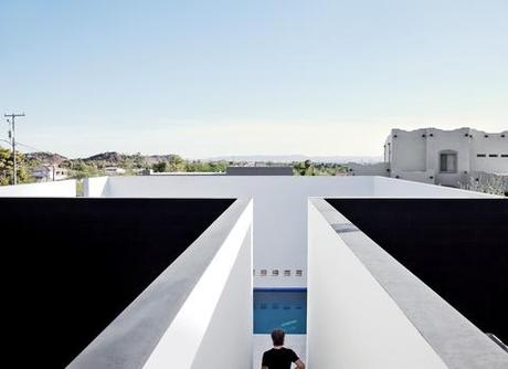 White plaster walls surrounding pool.