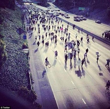 Halted: Traffic came to a halt Sunday evening on Los Angeles' I-10 freeway as Trayvon Martin supporters swarmed the road in protest of his killer's acquittal, stopping all traffic 