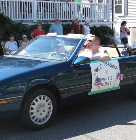 The Grand Marshall roles in a green LeBaron
