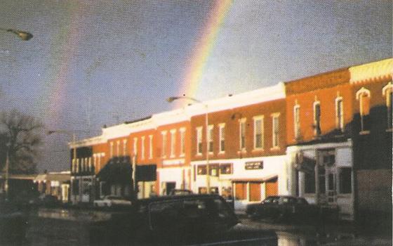 grainy old Polaroid photo showing rainbow arching onto walkup apartment in Tampico, Illinois where Ronald Reagan was born, taken by Lloyd McElhiney on November 3, 1980, day before Reagan was elected president