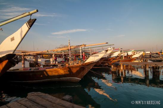 Approximately an hour after sunrise, the color of the light still gives a warm shadow/reflection to the dhows