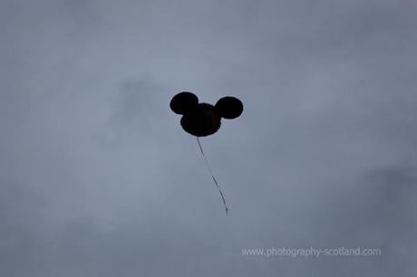 Photo - Micky Mouse balloon drifting off into the sky