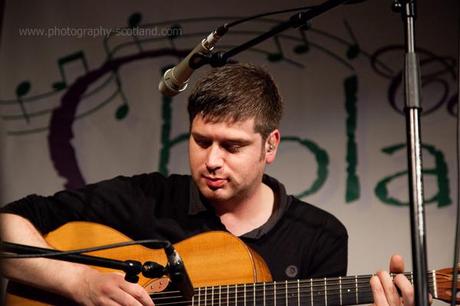 Photo - Kris  Drever, playing at Ceol Cholasa, Colonsay, September 2011