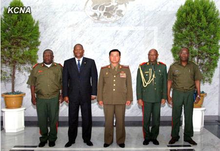 Minister of the People's Armed Forces Col. Gen. Jang Jong Nam (C) poses for a commemorative photograph with a military delegation from Mozambique in Pyongyang on 25 July 2013 (Photo: KCNA).