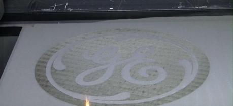 A new 1-kilowatt 3D laser printer is finishing the GE monogram. (See video below for final result.)