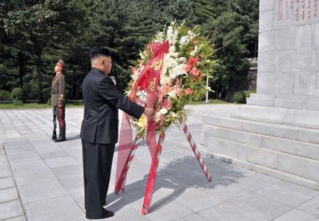 Kim Jong Un arranges a wreath on a floral basket delivered in his name to a monument at the CPV Martyrs' Cemetery in Hoech'ang County, South P'yo'ngan Province (Photo: Rodong Sinmun).