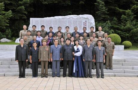 Kim Jong Un (5th L) poses for a commemorative photograph in front of a monument at Songhung Revolutionary Site on 29 July 2013