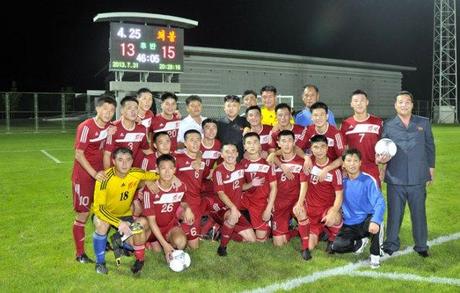 Kim Jong Un poses for a commemorative photograph with the players and coaches of the Hwaebul men's football (soccer) team after their victory over the 25 April men's team.  Also in the photo, R, is KIS Socialist  Youth League Central Committee Chairman Jon Yong Nam, holding the game ball (Photo: Rodong Sinmun).  