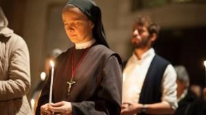 Catholic-nun-holds-a-candle-at-a-worship-service-via-Shutterstock-615x345