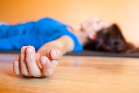 Woman lying in savasana. 