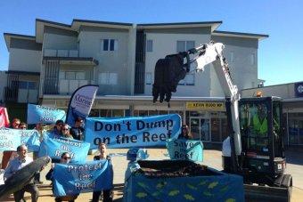 About 15 protesters dump a pile of mud outside Kevin Rudd's electorate office on August 5, 2013