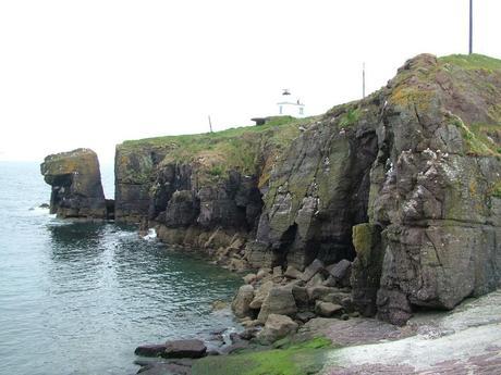 rock cliffs along shoreline at dunmore east in county waterford - ireland