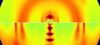 These X-ray images reveal the microscopic structure of two semiconducting plastic polymers. The bottom image, with several big crystals stacked in a row, is from a highly ordered polymer sample. The top image shows a disordered polymer with numerous tiny crystals that are barely discernible. (Credit: Jonathan Rivnay, Stanford, and Michael Toney, SSRL/SLAC)