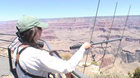Gabby use audio listening device to hear condor sounds at hopi point - grand canyon