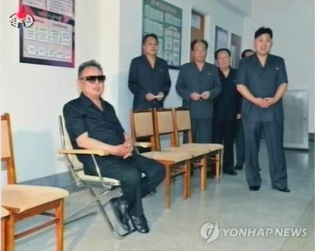 Kim Jong Un (R) visits the 11 May Factory with his father, late leader Kim Jong Il, in July 2011 (Photo: KCNA-Yonhap).