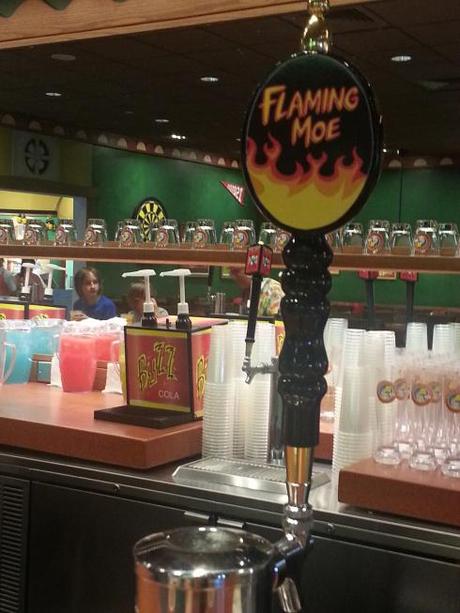 Sitting at the bar. The Flaming Moe is actually nonalcoholic. You can also get Duff, Duff Light, and Buzz Cola.