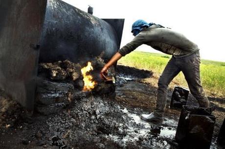 A farmhand feeds the fire under the oil boiler with distillery waste, producing oppressive smoke that stings the eyes and mouth. 