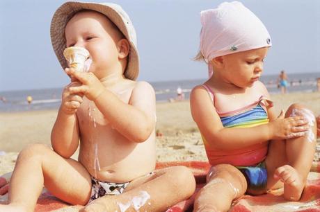 Toddlers having ice cream on the beach --- Image by © Royalty-Free/Corbis