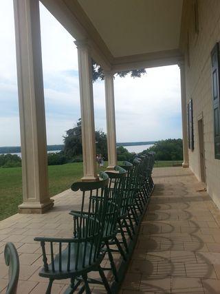 Chairs line the porch at Mt. Vernon. Great view of the Potomac