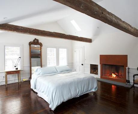 Master bedroom wooden beams gas fireplace Artemide lamp