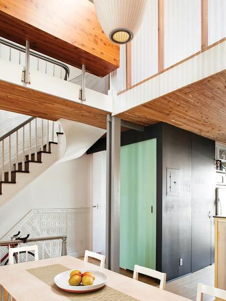 Dining area with a mint green door and cedar ceiling