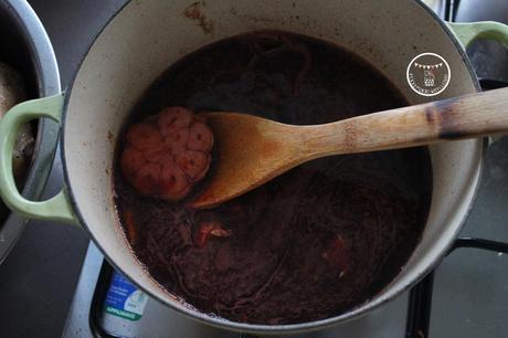 Bringing the wine mixture to a boil and reducing it
