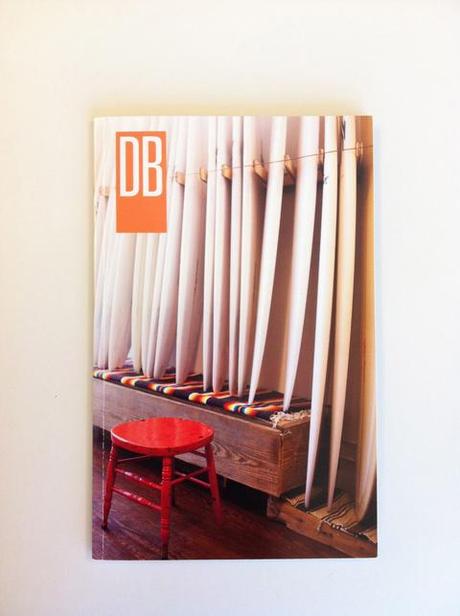 Front cover of Dennis Burnett's massive promotional booklet filled with his photography. surfboards red stool blanket interiors