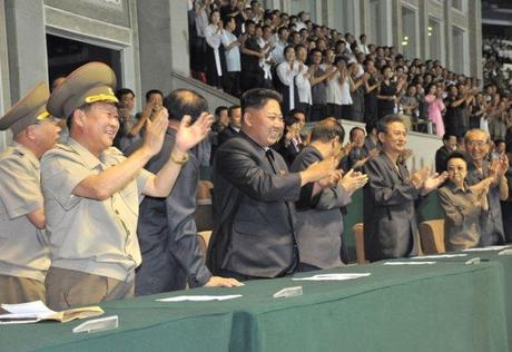 Kim Jong Un (3rd L) applauds during a men's premier league soccer (football) game at Kim Il Sung stadium in Pyongyang on 28 August 2013 (Photo: Rodong Sinmun).