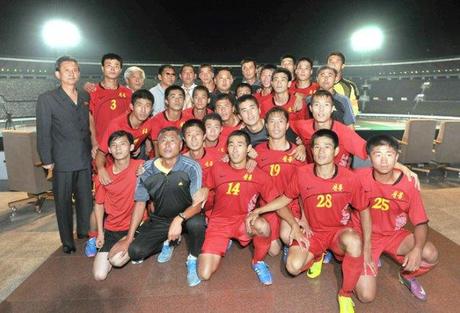 Kim Jong Un poses for a commemorative photograph with members and coaches of the Sonbong Team of the Worker Peasant Red Guards), who won the soccer (football) match.  Also seen in attendance (standing, L) is Col. Gen. O Il Jong, Director of the KWP Military Affairs Department (Photo: Rodong Sinmun).