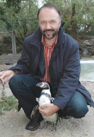 Andrey Kurkov poses with a penguin. (Photo: Random House UK)