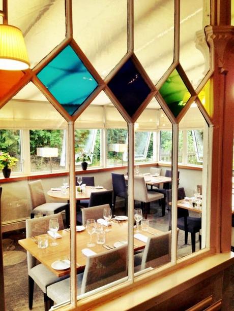 stained glass bright coloured windows in perkins restaurant plumtree nottingham looking into conservatory