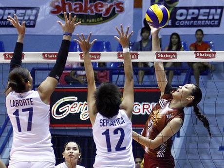 Maria Tabaquero of cagayan spikes the ball against two navy players.KC Cruz