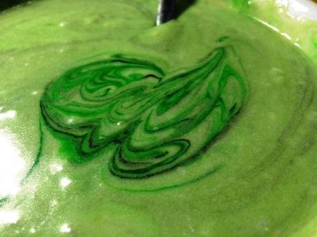 mixing green and black gel food color into cake batter for mojito bundt recipe