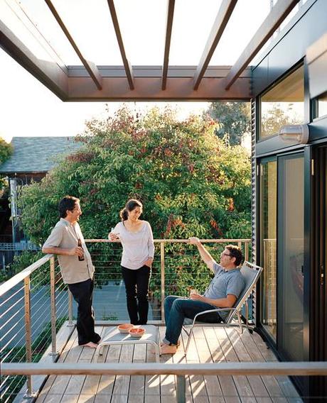 Balcony clad in concrete block, corrugated metal, and Parklex