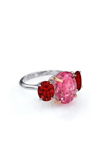 A deeply saturated, brilliant oval-shaped Pink Sapphire weighing approximately 7.00 carats, flanked by two oval-shaped extremely lively Rubies weighing  app. 3.00 carats total