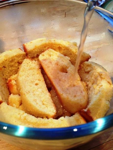 action shot photography pouring jelly onto madeira cake slices in pyrex glass bowl for trifle