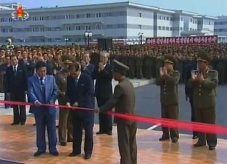 Pak Pong Ju cuts a ceremonial tape opening the U'nha Scientists Stree in Pyongyang (Photo: KCTV screengrab).