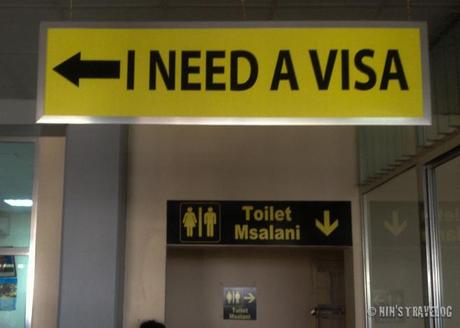 The signage of where to go to obtain visa for those who don't have visa. 