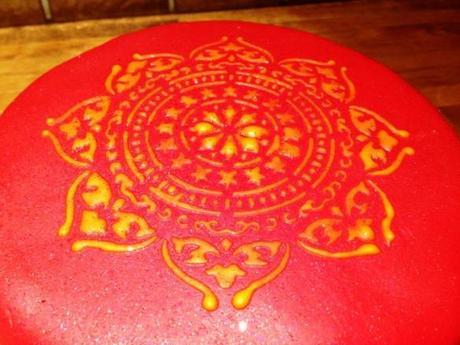 bright colours orange indian print ethnic stencil my cake decorating magazine on red fondant cake spiced bollywood nights