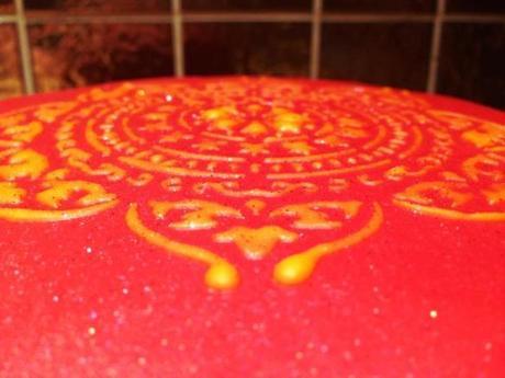 orange royal icing and edible glitter detail on bollywood nights treacle ginger and mango spiced cake recipe