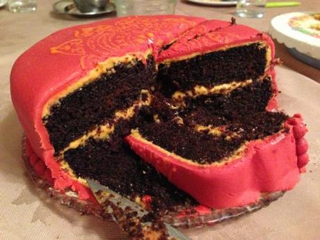 dark treacle and ginger cake with mango filling and red fondant bollywood decoration clandestine cake club