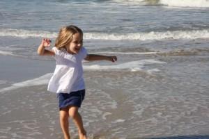 child jumping in ocean