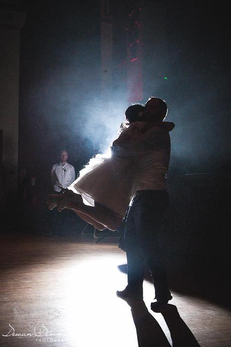 Groom spins bride around on dancefloor