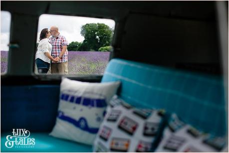 Couple kissing as seent hrought he window of a vintage VW camper van 
