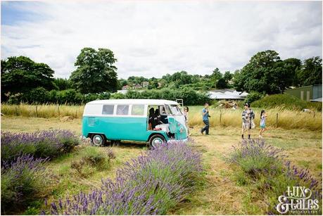 Onlookers walk away outside of a vW camper van 